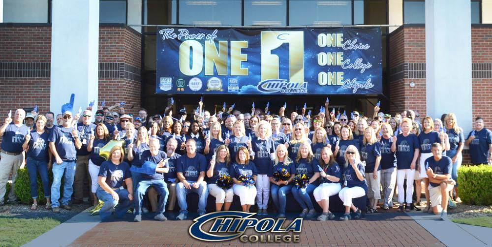 Group photo with logo power of one with chipola college staff standing outside in front of the student service building 